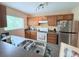 Efficient kitchen with stainless steel appliances, double sinks, and ample cabinet space at 1959 Toucan Way # 206, Sarasota, FL 34232