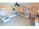 Open living room with a large sectional sofa and a ceiling fan at 1959 Toucan Way # 206, Sarasota, FL 34232