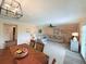 Open living room featuring a large sectional sofa, ceiling fan, and an adjacent dining area at 1959 Toucan Way # 206, Sarasota, FL 34232