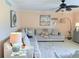 Relaxing living room featuring a large sectional sofa, ceiling fan, area rug, and built-in cabinetry at 1959 Toucan Way # 206, Sarasota, FL 34232