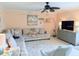 Relaxing living room featuring a large sectional sofa, ceiling fan, area rug, and built-in cabinetry at 1959 Toucan Way # 206, Sarasota, FL 34232