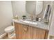 Updated bathroom with wood-grain vanity, marble countertop, modern faucet and decorative pulls at 2103 Harbourside Dr # 1102, Longboat Key, FL 34228
