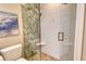 Bathroom features a modern glass shower with geometric white and herringbone accent tiles, and gold fixtures at 2103 Harbourside Dr # 1102, Longboat Key, FL 34228