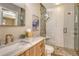 Modern bathroom features a marble vanity, sleek gold fixtures and frameless glass shower with decorative tile at 2103 Harbourside Dr # 1102, Longboat Key, FL 34228