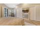 Neutral bedroom with closet, TV, and lots of natural light from sliding glass door at 2103 Harbourside Dr # 1102, Longboat Key, FL 34228