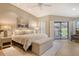 Bright and airy bedroom with walk-out, neutral color palette, and modern décor at 2103 Harbourside Dr # 1102, Longboat Key, FL 34228