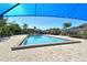 Community pool under a shade structure, featuring crystal-clear water, inviting seating, and lush landscaping at 2103 Harbourside Dr # 1102, Longboat Key, FL 34228