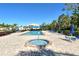 Community pool and spa with brick paver deck and lounge chairs under a sunny sky for relaxation and recreation at 2103 Harbourside Dr # 1102, Longboat Key, FL 34228