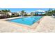 Bright and refreshing community pool with a clear blue water, ladder, and brick paver surround at 2103 Harbourside Dr # 1102, Longboat Key, FL 34228