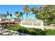 Harbour Oaks community sign surrounded by lush landscaping, welcoming residents and guests to the neighborhood at 2103 Harbourside Dr # 1102, Longboat Key, FL 34228