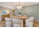 Dining room with a round table, designer chairs, and decorative accent wall at 2103 Harbourside Dr # 1102, Longboat Key, FL 34228