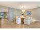 Dining area featuring modern decor, an elegant light fixture, and views to living room at 2103 Harbourside Dr # 1102, Longboat Key, FL 34228