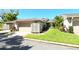 Charming single-story home with a well-manicured lawn, tile roof, and two-car garage at 2103 Harbourside Dr # 1102, Longboat Key, FL 34228
