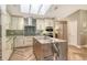 Bright kitchen with skylights and island that has a marble countertop and wood panelling at 2103 Harbourside Dr # 1102, Longboat Key, FL 34228