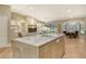Open-concept kitchen with a marble island, built-in shelving, and views of living and dining areas at 2103 Harbourside Dr # 1102, Longboat Key, FL 34228