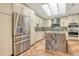 Bright kitchen featuring stainless steel appliances, island with marble countertop, and skylights at 2103 Harbourside Dr # 1102, Longboat Key, FL 34228