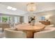 Open floor plan with dining and living spaces, showcasing natural light and stylish furnishings at 2103 Harbourside Dr # 1102, Longboat Key, FL 34228