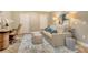 Cozy living room with neutral sofa, decorative pillows, rug, desk, and artwork for a comfortable atmosphere at 2103 Harbourside Dr # 1102, Longboat Key, FL 34228