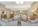 Elegant living room flows to dining area, featuring light wood floors and neutral decor at 2103 Harbourside Dr # 1102, Longboat Key, FL 34228