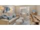 Comfortable living room with sofa, decorative pillows, rug, desk and view into dining area at 2103 Harbourside Dr # 1102, Longboat Key, FL 34228
