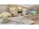 Bright and open living room with a view of the water and custom built in shelves at 2103 Harbourside Dr # 1102, Longboat Key, FL 34228