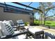 Enjoy the covered patio with stylish seating and views of the golf course at 2103 Harbourside Dr # 1102, Longboat Key, FL 34228