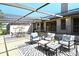 A relaxing screened patio with multiple seating areas is perfect for entertaining at 2103 Harbourside Dr # 1102, Longboat Key, FL 34228