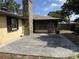 The backyard shows a concrete patio with access to a sun room and the exterior chimney at 211 55Th Nw St, Bradenton, FL 34209