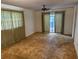 Bedroom with a ceiling fan and access to a private patio at 211 55Th Nw St, Bradenton, FL 34209