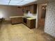 Open kitchen with laminate countertops, white appliances, and a view to the formal living room at 211 55Th Nw St, Bradenton, FL 34209