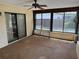 A covered patio with a ceiling fan and screened windows at 211 55Th Nw St, Bradenton, FL 34209