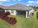Backyard featuring screened lanai and luscious landscaping at 2316 Springhaven Ln, Lakewood Ranch, FL 34211