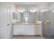 Modern bathroom features double vanity with granite countertop and glass-enclosed shower at 2316 Springhaven Ln, Lakewood Ranch, FL 34211