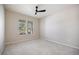 Bright bedroom with neutral carpet and window overlooking landscaping at 2316 Springhaven Ln, Lakewood Ranch, FL 34211