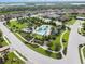 This beautiful community pool is surrounded by palm trees, lounge chairs, and shady cabanas at 2316 Springhaven Ln, Lakewood Ranch, FL 34211
