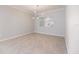 Open dining room with tile floors and modern chandelier lighting at 2316 Springhaven Ln, Lakewood Ranch, FL 34211