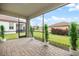 Screened lanai with brick floor and view of backyard at 2316 Springhaven Ln, Lakewood Ranch, FL 34211