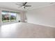 Bright living room featuring tile floors and sliding glass doors to outdoor patio at 2316 Springhaven Ln, Lakewood Ranch, FL 34211
