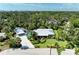 An aerial view showcases this property's pool, carport, lush surroundings and privacy at 2321 Milford Cir, Sarasota, FL 34239