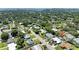 An aerial view displays the neighborhood and location of this property surrounded by lush greenery at 2321 Milford Cir, Sarasota, FL 34239