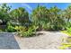 Backyard showcasing tropical landscaping and gravel ground cover, perfect for a serene outdoor space at 2321 Milford Cir, Sarasota, FL 34239