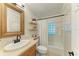 Charming bathroom featuring a rustic wood-framed mirror and a shower with glass block window at 2321 Milford Cir, Sarasota, FL 34239