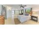 Cozy bedroom featuring a ceiling fan, outdoor access, and large windows providing natural light at 2321 Milford Cir, Sarasota, FL 34239