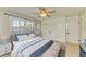 Serene bedroom featuring a ceiling fan, bright windows with shutters, and closet at 2321 Milford Cir, Sarasota, FL 34239