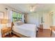 Inviting bedroom with hardwood floors, a ceiling fan, and a closet with louvered doors at 2321 Milford Cir, Sarasota, FL 34239