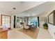 Sunlit dining area with stylish furniture, neutral tones, and direct access to the outdoor pool area at 2321 Milford Cir, Sarasota, FL 34239
