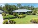 Charming home with a metal roof and meticulously landscaped front yard, exuding curb appeal at 2321 Milford Cir, Sarasota, FL 34239