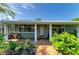 Inviting home exterior featuring a lovely brick porch, tidy landscaping, and attractive curb appeal at 2321 Milford Cir, Sarasota, FL 34239