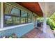 Enchanting front porch with painted brickwork, large windows, and tiled floor leading to the entrance at 2321 Milford Cir, Sarasota, FL 34239