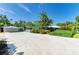 Spacious property featuring a lush landscape, ample parking, and a detached garage with a carport at 2321 Milford Cir, Sarasota, FL 34239